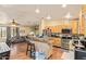 Spacious kitchen with stainless appliances, wood cabinets, and open view to the living area at 7259 E Glencove St, Mesa, AZ 85207