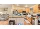 Open kitchen with stainless appliances, island and bar seating at 7259 E Glencove St, Mesa, AZ 85207