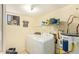 Practical laundry room with washer, dryer, water heater, and storage shelves for convenience at 7259 E Glencove St, Mesa, AZ 85207