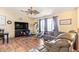 Inviting living room with hardwood floors, neutral walls, ceiling fan, and a cozy seating area at 7259 E Glencove St, Mesa, AZ 85207