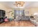 Bright living room with hardwood floors, large windows, neutral walls, ceiling fan, and a comfortable seating area at 7259 E Glencove St, Mesa, AZ 85207