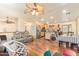 Open-concept living space featuring hardwood floors, with sightlines to the kitchen and dining area at 7259 E Glencove St, Mesa, AZ 85207