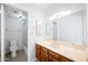 This bathroom features a well-lit vanity with mirror and cabinet with a tub and shower beyond at 8314 N 21St Dr # K208, Phoenix, AZ 85021