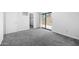 This bedroom offers neutral carpet, a sliding glass door, and a convenient closet area at 8314 N 21St Dr # K208, Phoenix, AZ 85021
