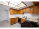 Well-lit kitchen with wooden cabinets, light countertops, and modern appliances at 8314 N 21St Dr # K208, Phoenix, AZ 85021