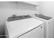 Bright laundry room features a newer Samsung washer and dryer, with shelf above for storing supplies at 8314 N 21St Dr # K208, Phoenix, AZ 85021