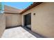 A concrete patio with privacy wall features a storage door and access to the interior at 8314 N 21St Dr # K208, Phoenix, AZ 85021