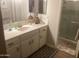 Well-lit bathroom with a neutral color scheme, a sleek countertop, and a glass-enclosed shower at 1036 E Wagon Wheel Dr, Phoenix, AZ 85020