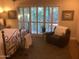 Inviting bedroom featuring a wrought iron bed frame with plush furnishings and view to the outside at 1036 E Wagon Wheel Dr, Phoenix, AZ 85020