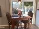 Cozy dining area with a table set for two next to sliding glass door to backyard at 1036 E Wagon Wheel Dr, Phoenix, AZ 85020