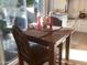Bright dining area with a wooden table set next to a sliding glass door leading to the outside at 1036 E Wagon Wheel Dr, Phoenix, AZ 85020
