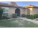 Charming brick home featuring an arched entryway and neatly manicured landscaping at 1036 E Wagon Wheel Dr, Phoenix, AZ 85020
