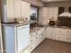 Bright kitchen features white cabinets, granite countertops, stainless steel appliances, and a farmhouse sink at 1036 E Wagon Wheel Dr, Phoenix, AZ 85020