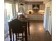 Kitchen featuring white cabinets, tiled backsplash, stainless steel appliances, and an adjacent dining area at 1036 E Wagon Wheel Dr, Phoenix, AZ 85020