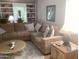Living room featuring a sectional sofa, round coffee table, and bright window at 1036 E Wagon Wheel Dr, Phoenix, AZ 85020