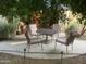 Tranquil outdoor seating area featuring a table and chairs under a shaded canopy, lit by garden lights at 1036 E Wagon Wheel Dr, Phoenix, AZ 85020