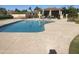 Enjoy the sunshine in the community pool with lounge chairs and tables under shaded umbrellas at 1036 E Wagon Wheel Dr, Phoenix, AZ 85020