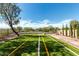 Artificial turf backyard with desert landscaping, fire pit, and iron view fencing at 10830 W El Cortez Pl, Peoria, AZ 85383