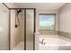 Bathroom with walk-in shower, bathtub, and frosted window at 10830 W El Cortez Pl, Peoria, AZ 85383