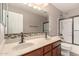 Well-lit bathroom featuring double sinks, modern fixtures, and a glass-enclosed shower at 10830 W El Cortez Pl, Peoria, AZ 85383