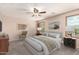 Staged bedroom with neutral walls, ceiling fan, and carpeted floor at 10830 W El Cortez Pl, Peoria, AZ 85383