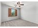 Bedroom features carpeted floors, ceiling fan, and window with wooden shutters at 10830 W El Cortez Pl, Peoria, AZ 85383