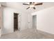 Bedroom features carpeted floors, a ceiling fan, and several entryways at 10830 W El Cortez Pl, Peoria, AZ 85383