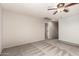 Spacious bedroom with neutral walls, ceiling fan, and carpeted floor at 10830 W El Cortez Pl, Peoria, AZ 85383