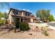 Beautiful two-story home with desert landscaping and a paved driveway on a sunny day at 10830 W El Cortez Pl, Peoria, AZ 85383