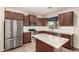 Modern kitchen featuring stainless steel appliances, a center island, and sleek cabinetry at 10830 W El Cortez Pl, Peoria, AZ 85383