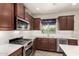This bright kitchen features stainless appliances, and a window with a view to the outside at 10830 W El Cortez Pl, Peoria, AZ 85383
