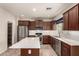 Well-equipped kitchen features stainless appliances, white backsplash, and island with white countertop at 10830 W El Cortez Pl, Peoria, AZ 85383