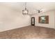Spacious living room featuring tile floors, a ceiling fan, modern lighting, and a view to the outside at 10830 W El Cortez Pl, Peoria, AZ 85383