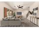 Comfortable living room with a plush sofa, ceiling fan, and view to the front yard at 10830 W El Cortez Pl, Peoria, AZ 85383