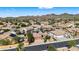 Scenic aerial view of a neighborhood with desert landscaping and homes featuring solar panels and tile roofs at 10897 S Turtle Dove S Dr, Goodyear, AZ 85338