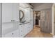 Bathroom with vanity, a bowl sink, white cabinets and a closet with a barn door at 10897 S Turtle Dove S Dr, Goodyear, AZ 85338