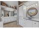 Bathroom featuring double sink vanity, white cabinets and a large mirror at 10897 S Turtle Dove S Dr, Goodyear, AZ 85338