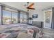 Bright main bedroom features a ceiling fan, natural light and wood-look flooring at 10897 S Turtle Dove S Dr, Goodyear, AZ 85338