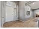 Welcoming foyer featuring tile floors, high ceilings, and a view of the laundry room at 10897 S Turtle Dove S Dr, Goodyear, AZ 85338