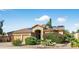 Charming single-story home with desert landscaping, a three-car garage, and solar panels at 10897 S Turtle Dove S Dr, Goodyear, AZ 85338