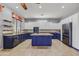 Spacious kitchen featuring granite countertops, stainless steel appliances and custom blue island at 10897 S Turtle Dove S Dr, Goodyear, AZ 85338