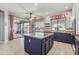 Bright kitchen with granite countertops, blue cabinets and a view of an outdoor living space at 10897 S Turtle Dove S Dr, Goodyear, AZ 85338