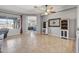 Open-concept living room featuring tile floors, neutral colors, and decorative wall art at 10897 S Turtle Dove S Dr, Goodyear, AZ 85338