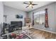 Office featuring a ceiling fan, large window, desk, and television at 10897 S Turtle Dove S Dr, Goodyear, AZ 85338