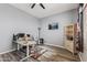 Office featuring a ceiling fan, large window, desk, and television at 10897 S Turtle Dove S Dr, Goodyear, AZ 85338