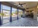 Enclosed outdoor living area with brick flooring, ceiling fans and a view of the pool at 10897 S Turtle Dove S Dr, Goodyear, AZ 85338