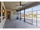 Enclosed outdoor living area with brick flooring, ceiling fans and a view of the backyard at 10897 S Turtle Dove S Dr, Goodyear, AZ 85338