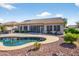 Beautiful backyard pool with patio, pergola, and meticulously maintained desert landscaping at 10897 S Turtle Dove S Dr, Goodyear, AZ 85338