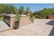 Travertine patio with a hot tub, artificial lawn, and desert landscaping at 11025 N 10Th St, Phoenix, AZ 85020