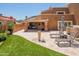 Expansive backyard featuring travertine patio, artificial grass, and desert landscaping at 11025 N 10Th St, Phoenix, AZ 85020